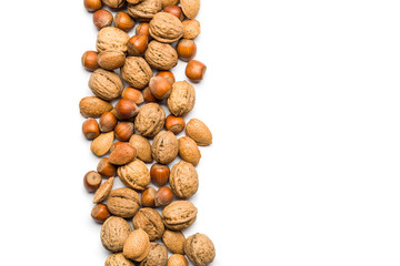 top view of mix of nuts scattered on white background with copy space