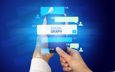 Female hand typing on smartphone with SOCIAL GRAPH inscription, social networking concept