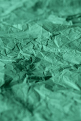 Texture of crumpled turquoise paper. Rough recycled paper background for design.  