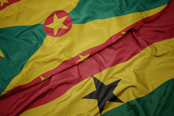 waving colorful flag of ghana and national flag of grenada.