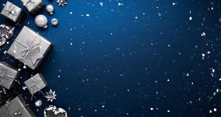 Merry Christmas ornaments and gift on blue background top view. Xmas and new year holiday theme....