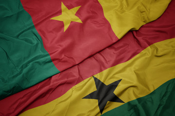 waving colorful flag of ghana and national flag of cameroon.