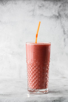 Berries Smoothie Or Raspberry Pink Red Milkshake In Glass On Bright Marble Background. Overhead View, Copy Space. Advertising For Milkshake Cafe Menu. Coffee Shop Menu. Vertical Photo.