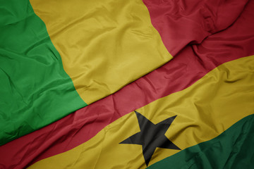 waving colorful flag of ghana and national flag of mali.