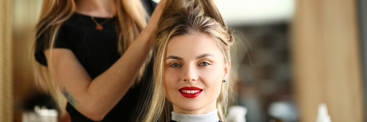 Fototapeta premium Girl Client Getting Hairstyle by Hairdresser