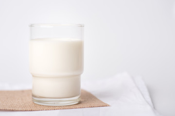 Fresh milk in a glass on a white background, healthy concept