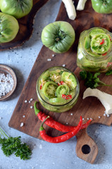 Pickled green tomatoes with herbs, horseradish, pepper and garlic