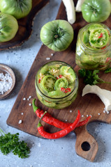 Pickled green tomatoes with herbs, horseradish, pepper and garlic