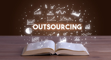 OUTSOURCING inscription coming out from an open book, business concept