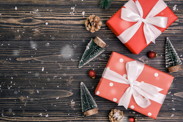 Christmas holiday composition with red gift box decoration on wooden background, new year and xmas or anniversary with presents on wood table in season, top view or flat lay.