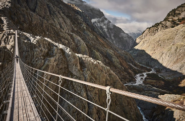 Mountaineers crossing the suspension bridge of Trift (Triftbrücke). Switzerland