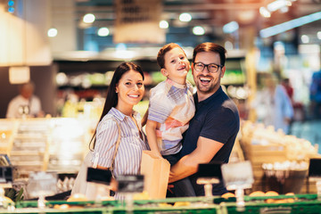 Family buying fruit in supermarket