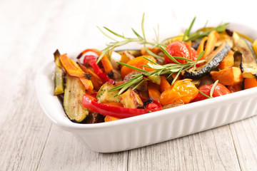 roasted vegetable and herb on wood background