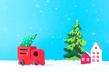 Creative christmas composition. Red car carries a Christmas tree. Paper art of Merry Christmas and New Year. Copy space.