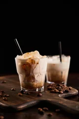  white russian cocktail in glasses with straws on wooden board with coffee grains isolated on black © LIGHTFIELD STUDIOS