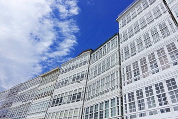 Fototapeta premium White facades of houses with glazed balconies