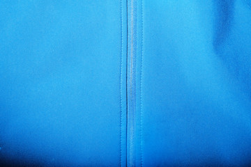 Detailed view of softshell jacket with water drops, zipper and seams. blue background © North10