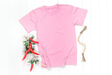 Pink T-shirt on a White Wooden Background