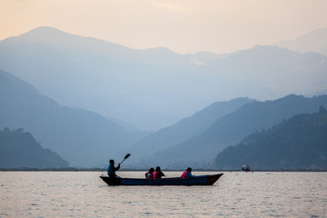 Tourist on a boat on the Phewa lake in Pokhara, Nepal