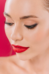 close up view of naked beautiful woman with red lips isolated on red