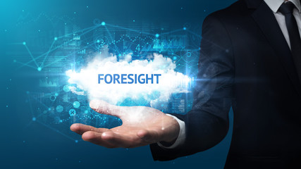 Hand of Businessman holding FORESIGHT inscription, successful business concept