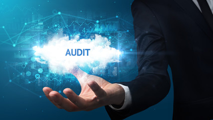 Hand of Businessman holding AUDIT inscription, successful business concept