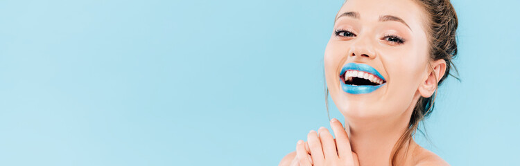 laughing naked beautiful woman with blue lips isolated on blue, panoramic shot