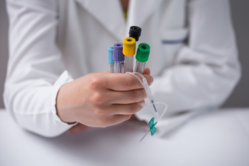 Doctor hand holding Blood test tubes and equipment. Blood test and donation concept. Doctor holding blood sample tube testing in the laboratory, technician holding blood tube sample in the lab