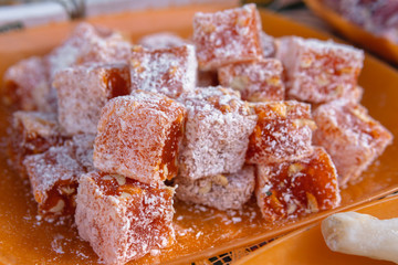 Different types, assorted. Tasty oriental sweets (Turkish delight lokum) with powdered sugar. bright and colorful sweets