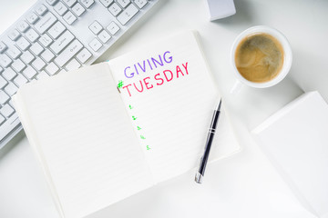 Notepad for To-Do list Giving Tuesday. White paper ready to write notes to various helping on...
