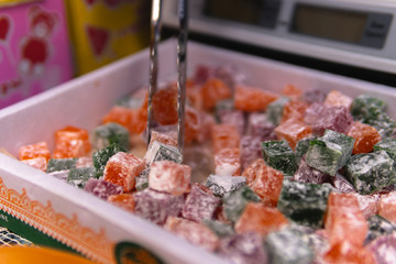 Different types, assorted. Tasty oriental sweets (Turkish delight lokum) with powdered sugar. bright and colorful sweets
