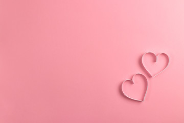 Composition for Valentine's Day February 14th. Delicate pink background and pink hearts cut out of...