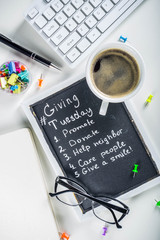 Chalk board with list of tasks, ideas, task for Giving Tuesday. Notes to various helping on...