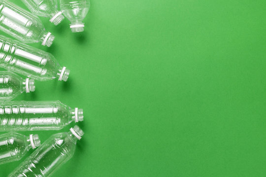 Composition of plastic waste pollution. Sorting and recycling. Disposable plastic bottles for water. Ecological concept. Flat lay, top view, copy space.