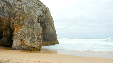 Wild Atlantic ocean coast at Adraga Beach in Portugal - travel photography