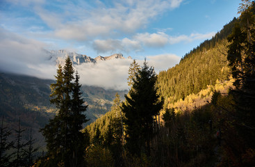 The last rays of the sun illuminate the slope of the Sätteli and the Gadmen valley, seen from the trail to the suspension bridge of Trift (Triftbrücke). Switzerland