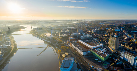 An aerial view at sunrise of Newport city centre, south wales United Kingdom, taken from the River Usk - obrazy, fototapety, plakaty
