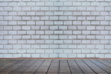 Background of aged grungy textured white brick and stone wall with light wooden floor with whiteboard inside old