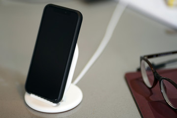 mobile phone on the table. modern wireless charger 