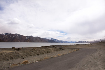 View landscape with Himalayas mountains and Pangong Tso high grassland lake while winter season for indian and tibetan and foreigner travelers travel visit at Leh Ladakh in Jammu and Kashmir, India