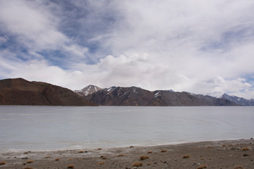 Fototapeta na wymiar View landscape with Himalayas mountains and Pangong Tso high grassland lake while winter season for indian and tibetan and foreigner travelers travel visit at Leh Ladakh in Jammu and Kashmir, India