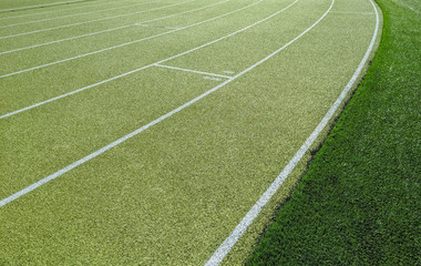 Green running track on athletic stadium