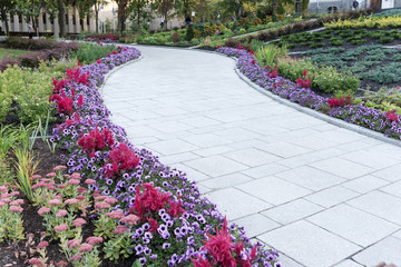 Garden stone path with flowers on the edge