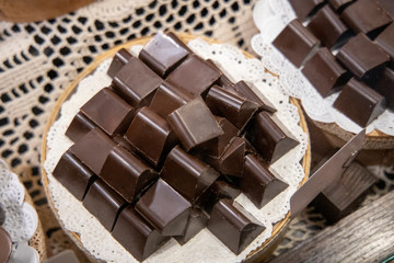 Assortment of fine chocolate candies, white, dark, and milk chocolate Sweets background. Copy space. Top view.