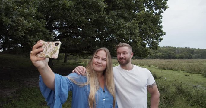 Couple taking a selfie and are in love. Cinematic lifestyle scene perfect for corporate or lifestyle video projects.