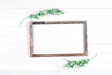 Spring or summer wooden frame mockup with greenery