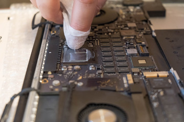 Specialist repairs laptop, close-up details