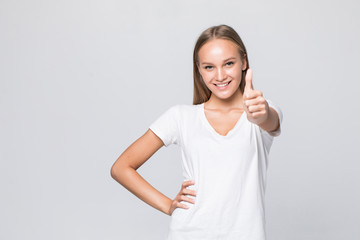 Young casual woman smiling with her thumbs up isolated on white background
