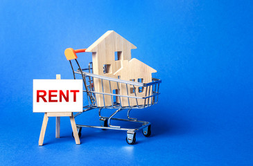 Houses in a shopping cart and an easel with a word Rent. Rental housing and apartments, choice...