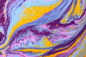 Abstract colored background from spilled paints closeup